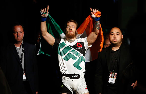 Conor McGregor walks to the Octagon to face Chad Mendes in their UFC interim featherweight title fight during the UFC 189 event inside MGM Grand Garden Arena on July 11, 2015 in Las Vegas, Nevada. (Photo by Christian Petersen/Zuffa LLC/Zuffa LLC via Getty Images)